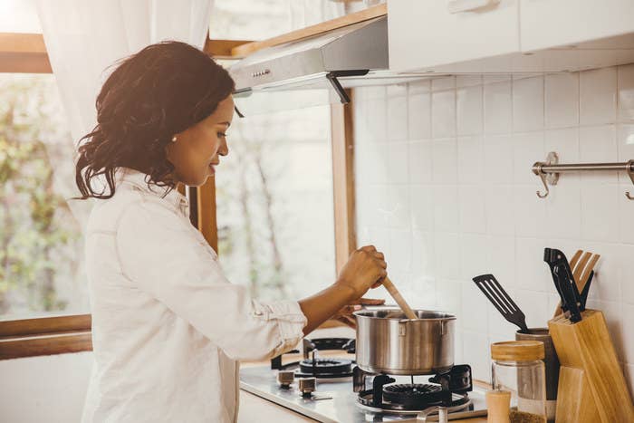 woman stirring cooking pot