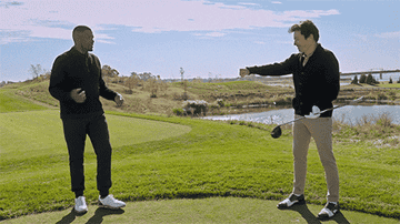 Jimmy Fallon does a socially distanced fist bump on the golf course