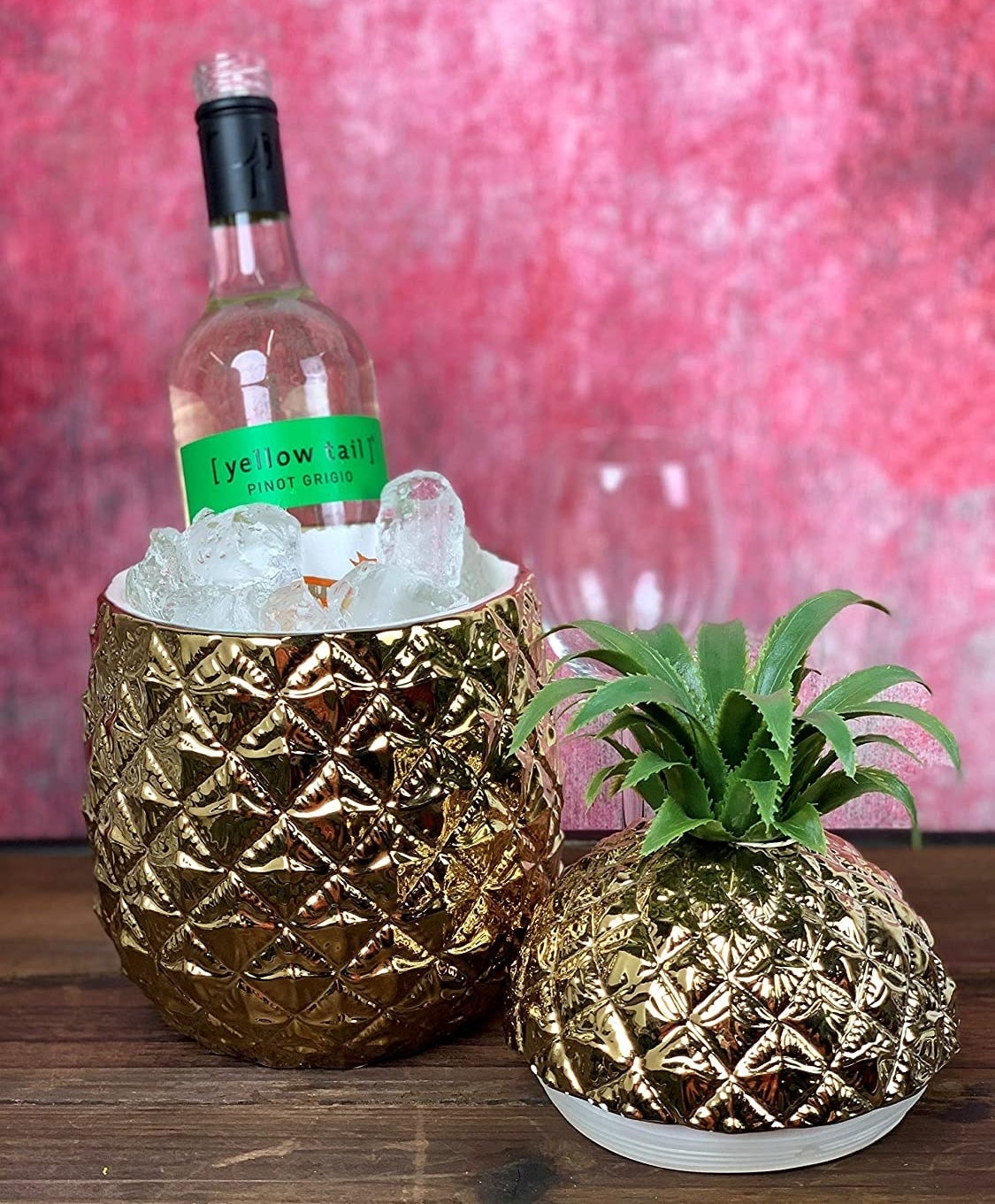 A large pineapple ice bucket chilling a bottle of wine