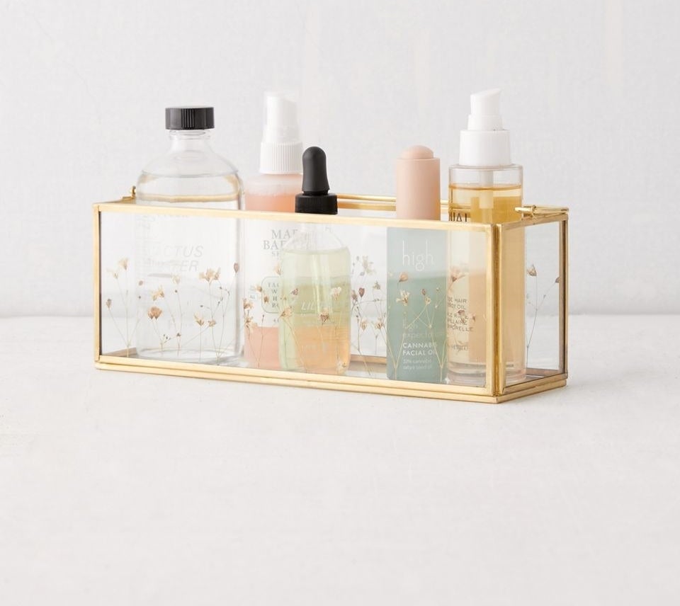 glass rectangular organizer with gold trim and pressed flowers in the glass