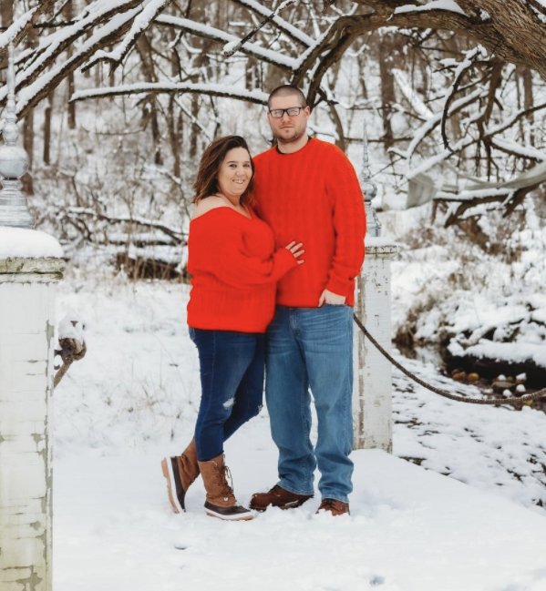 Two people wearing the sweater