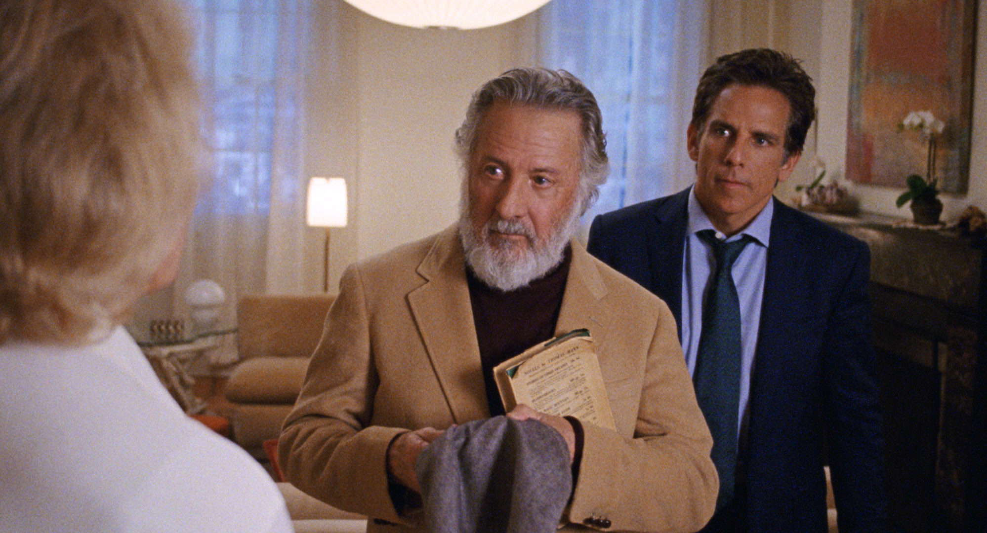 Dustin Hoffman and Ben Stiller stand listening to an off screen person