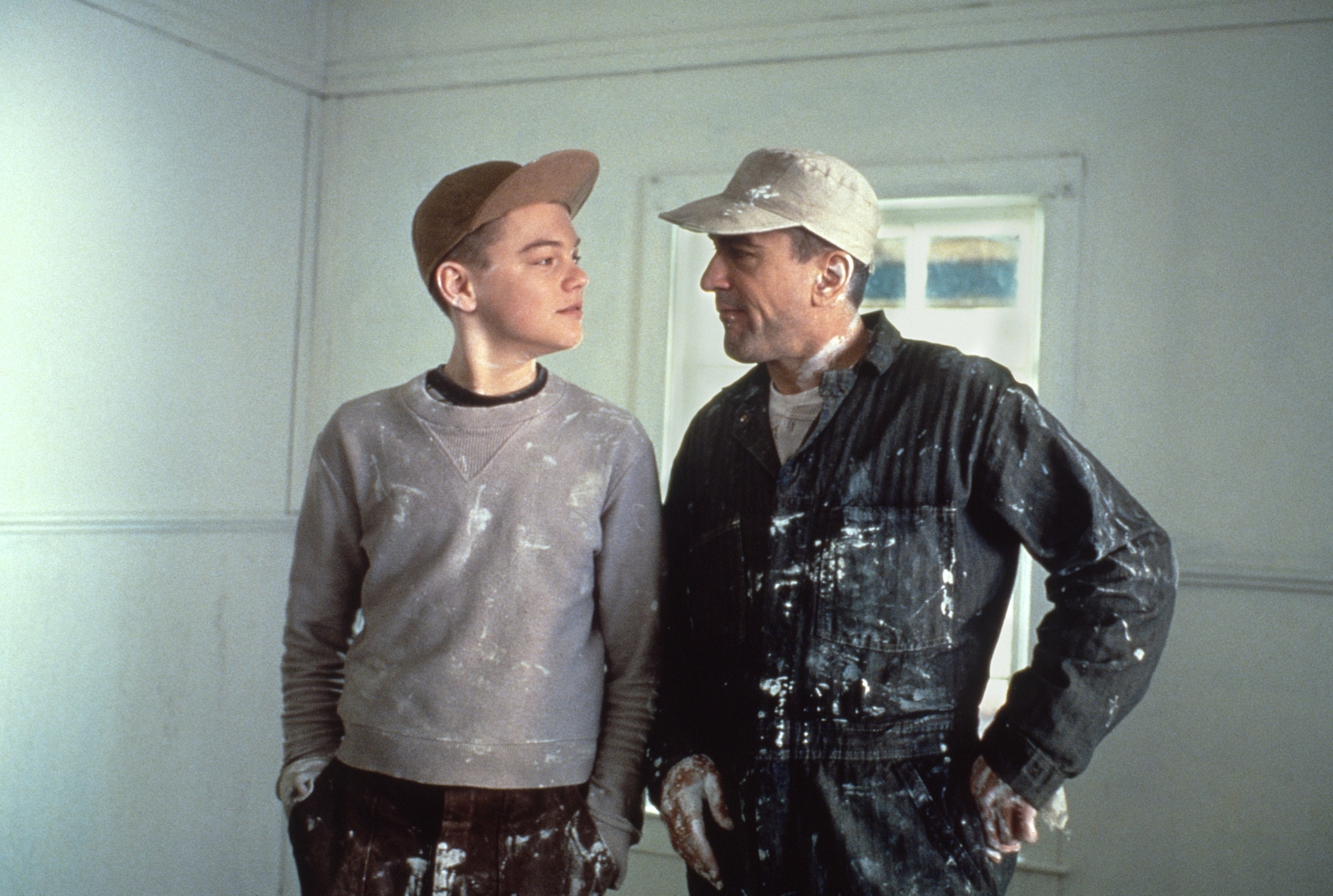 Leonardo DiCaprio and Robert De Niro look at each other after finishing painting