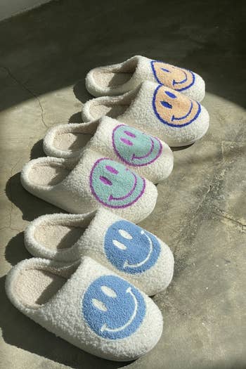 three pairs of slippers in different colors