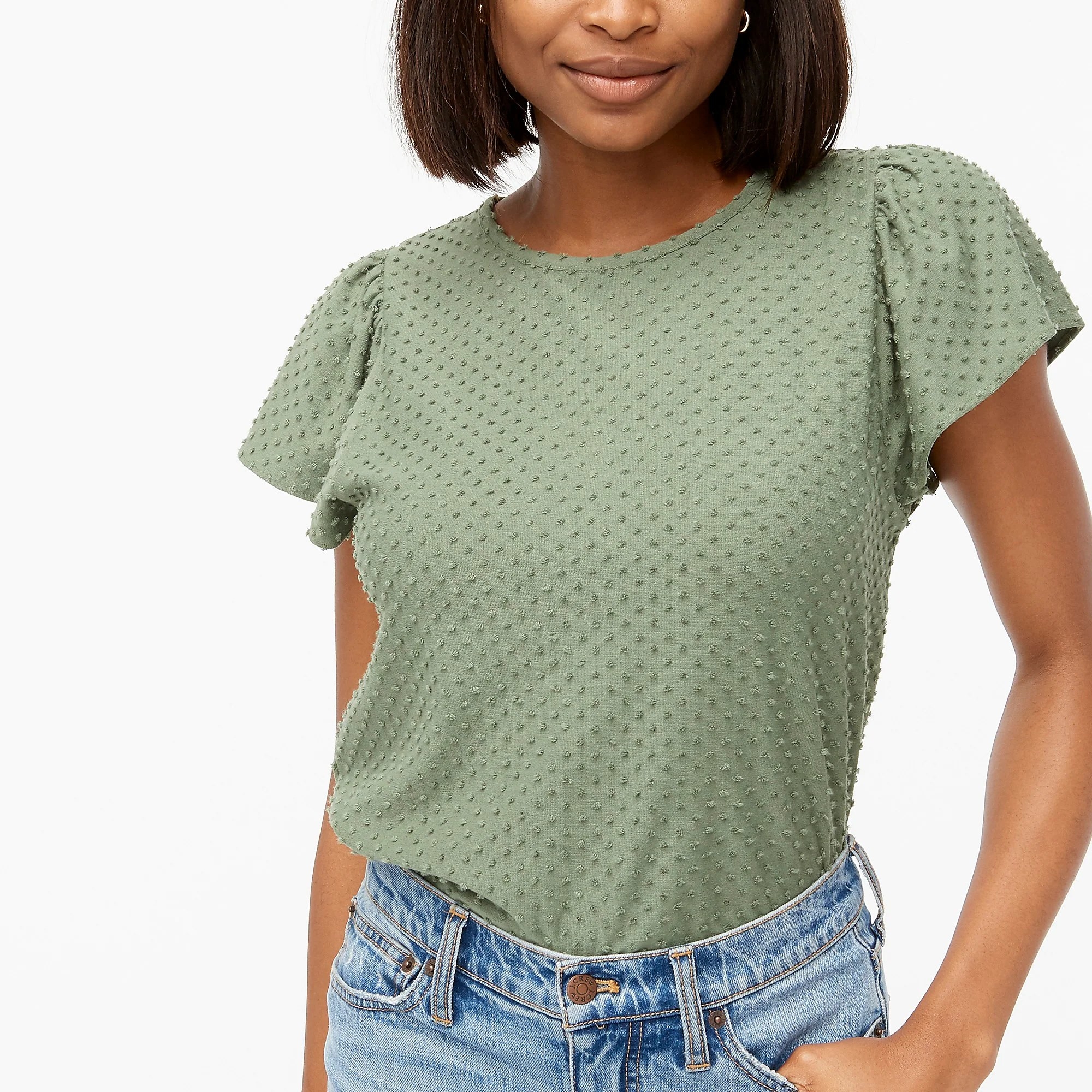 A model wearing the top tucked into jeans
