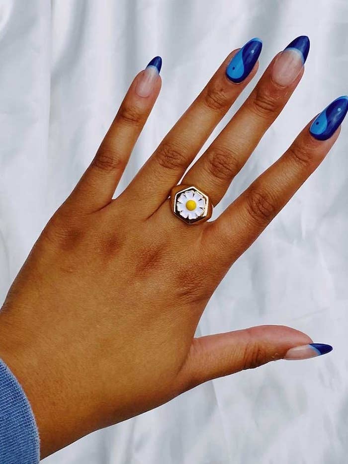 gold ring with white and yellow daisy