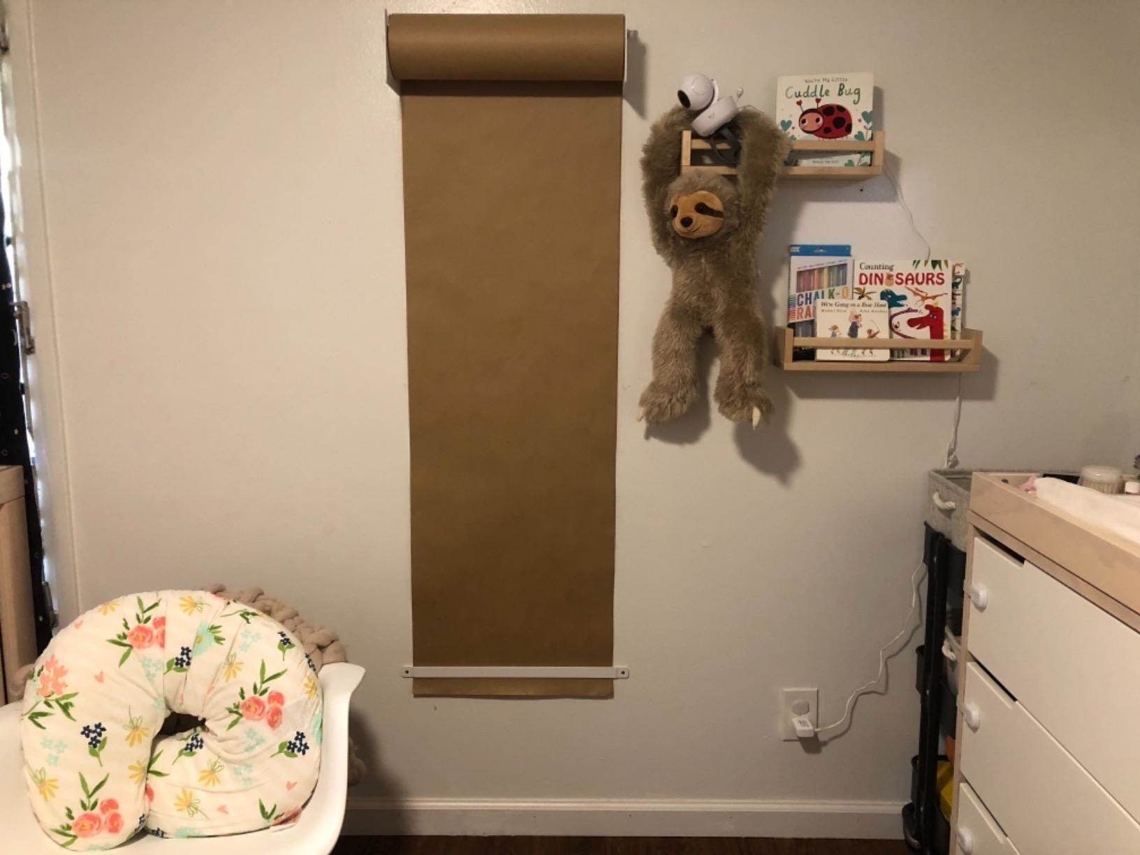 Reviewer&#x27;s photo of the kraft paper roll displayed in a kid&#x27;s room
