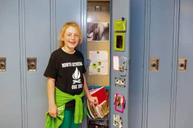 a young student by her decorated locker