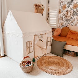 Reviewer's photo showing the cream play tent in their kid's room
