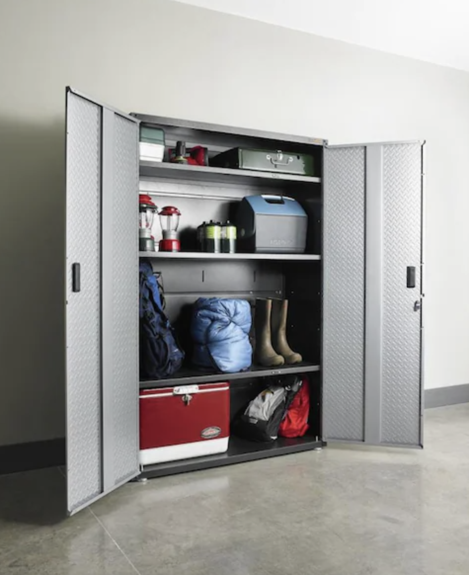 A metal open door cabinet with three shelves holding weather gear and supplies