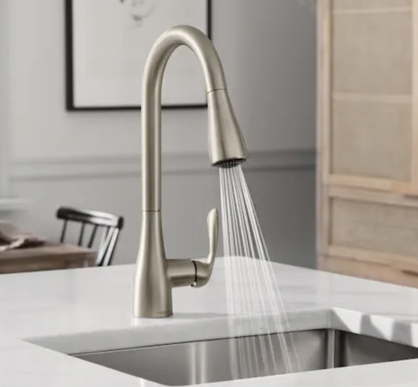 Curved faucet spraying into a sink