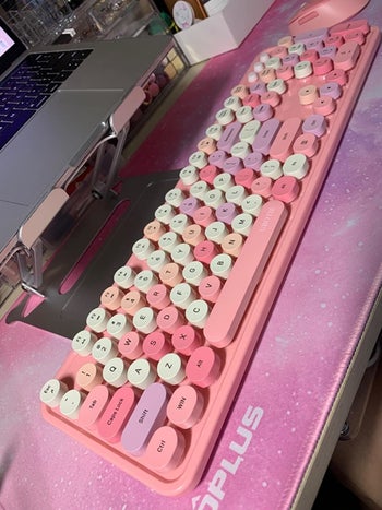 reviewer's pink keyboard on their desk
