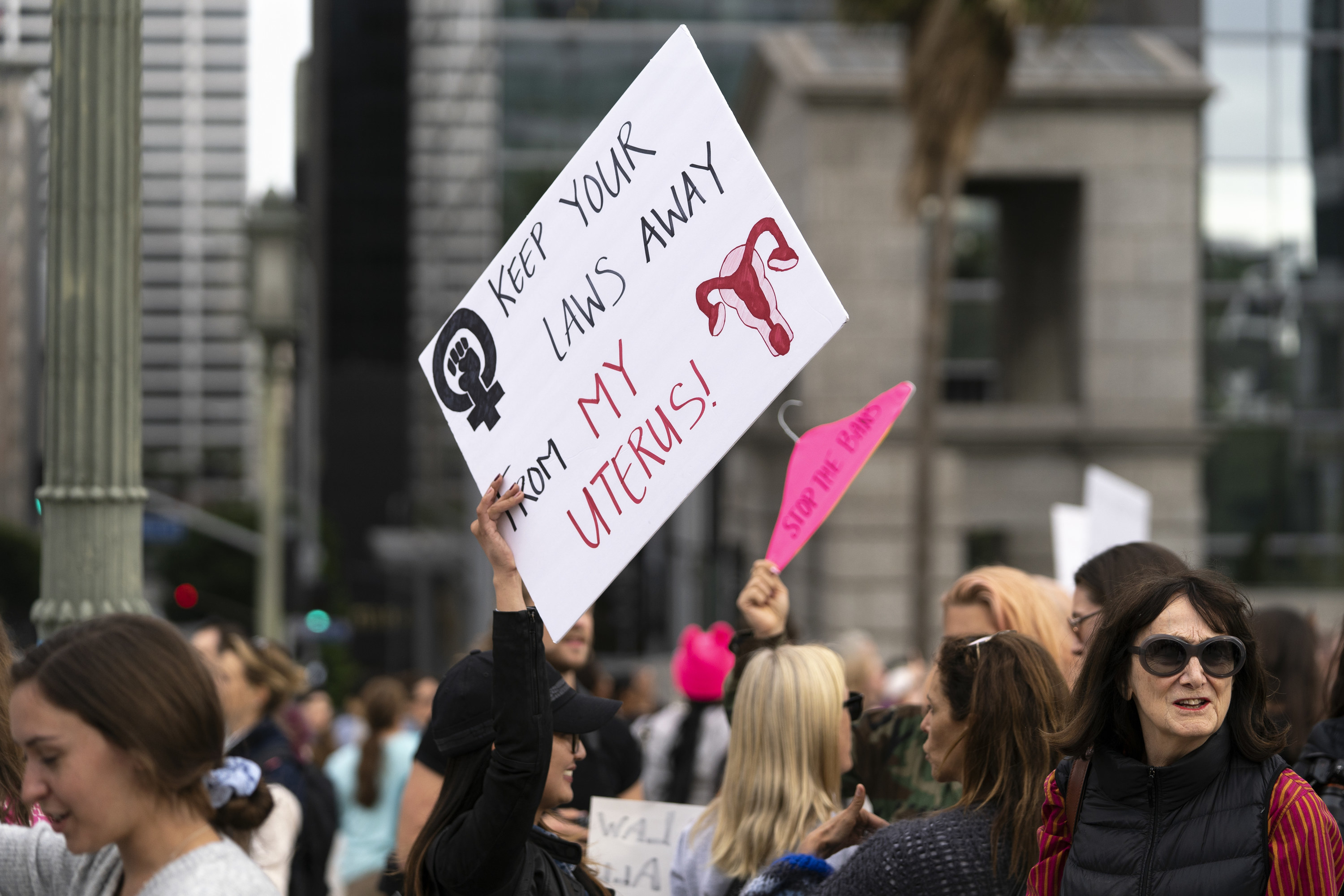 An activist seen holding a placard that says &#x27;keep your laws away from my uterus&#x27; during the protest