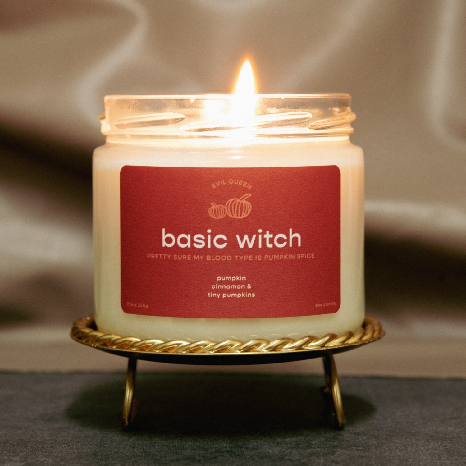 a candle with an orange label on it that says &quot;basic witch, pretty sure my blood type is pumpkin spice&quot;