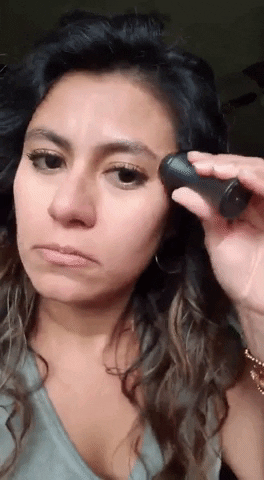 gif of a reviewer using the revlon oil-absorbing volcanic face roller