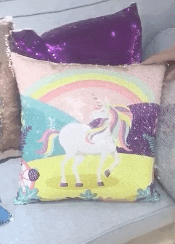 a gif of a hand swiping the pillow to reveal a photo and then solid-colroed sequins 