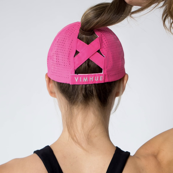 Model showing back of the hat where there's a cross hatch design to support a high ponytail 