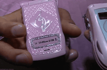GIF close-up of a hand holding a pink Baby Phat phone
