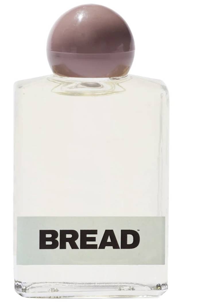 The hair oil bottle says "BREAD" with a light green stripe and taupe rounded lid