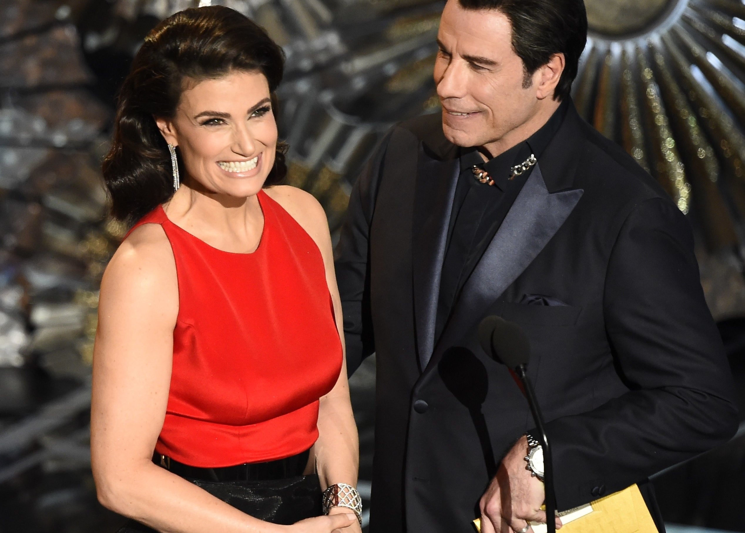 Idina and John smile while sharing the stage at a later time