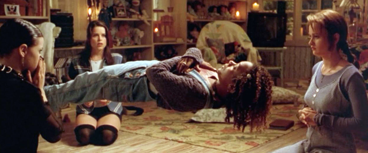 A still from the movie, The Craft, in which girls succeed in levitating their friend by playing &quot;Light as a feather, stiff as a board&quot;