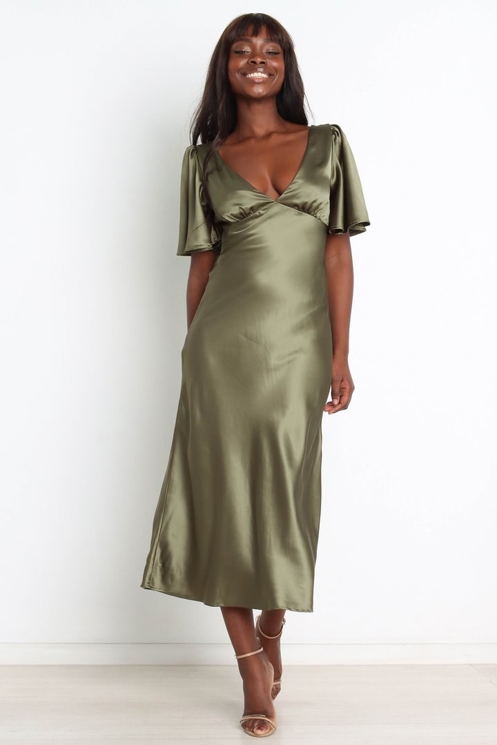 A model in the olive green satin dress