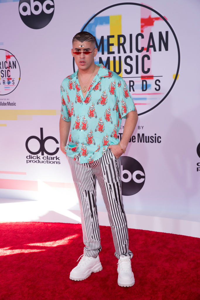 striped pants, skulls on fire printed shirt, and a third eye painted on his forehead