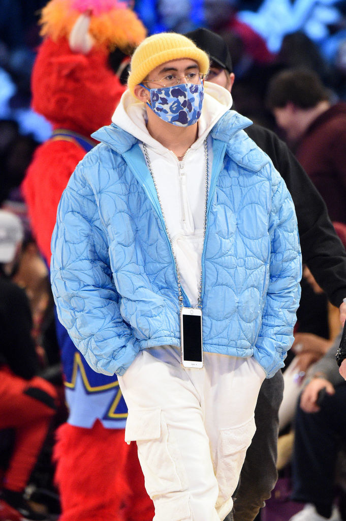 oversized puffer jacket, tight-fitting beanie, and his phone on a chain