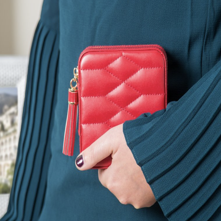 The red version zipped in a model's hand 