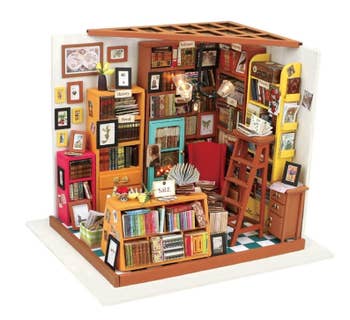 the miniature library diorama filled with books and furniture