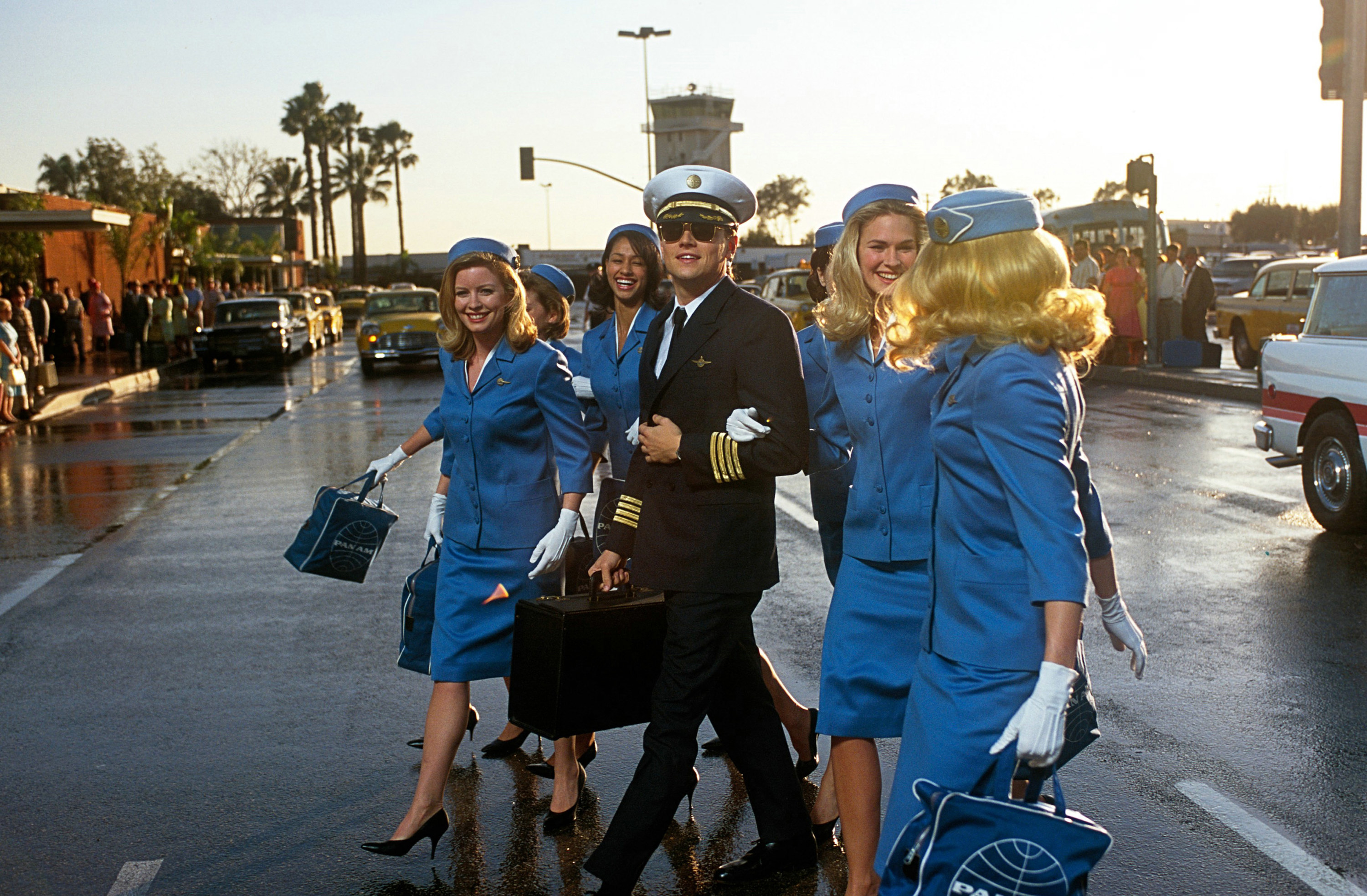 Leonardo DiCaprio walking with a group of flight attendants in &quot;Catch Me if You Can&quot;