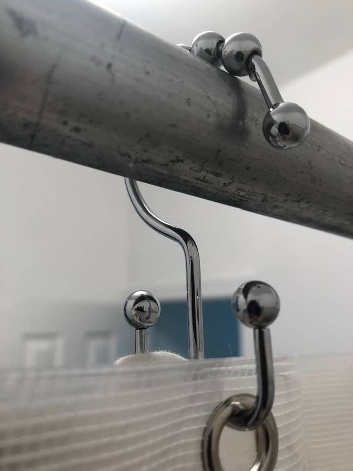closeup of double hook shower curtain hook