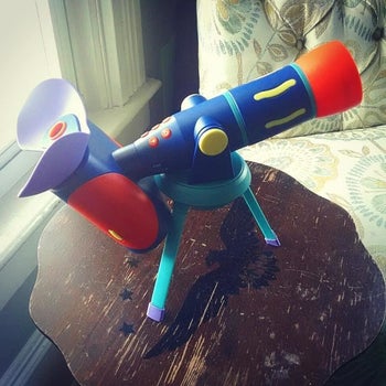 Reviewer's photo of blue plastic toy telescope