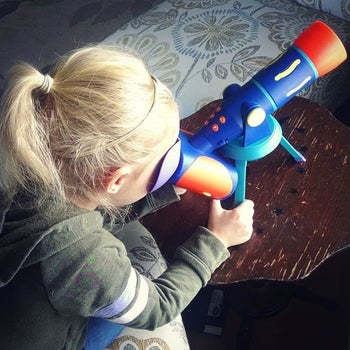Reviewer's photo of child playing with telescope