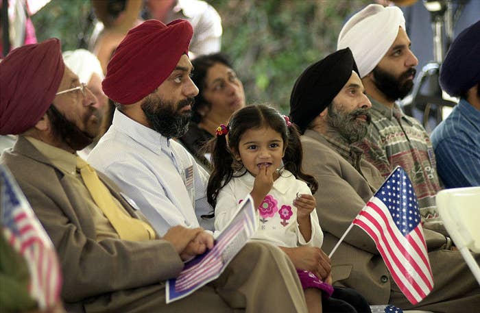 In this photo, I was almost 3 years old, sitting in my father&#x27;s lap at a 9/11 memorial.
