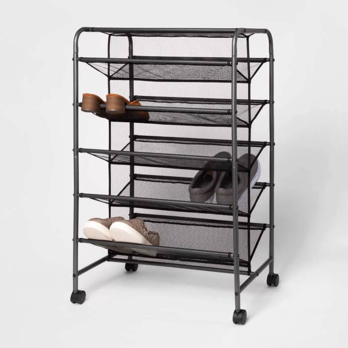 The shoe rack with a few pairs of shoes on it