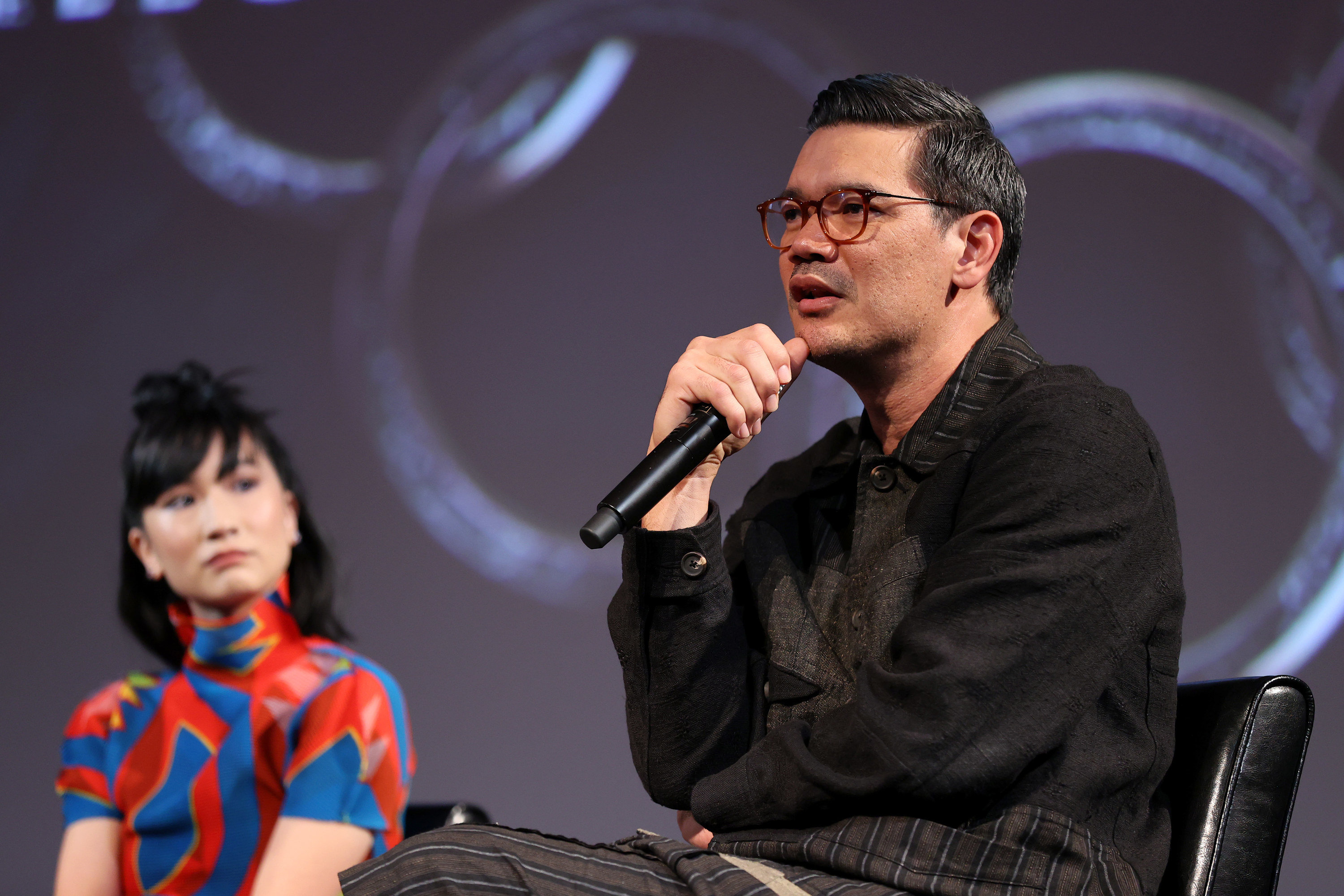 A woman and a man speaking onstage