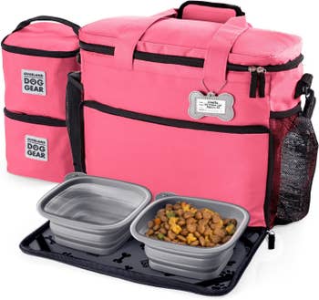 The pink travel bad with water and food in the two dishes that are included with it
