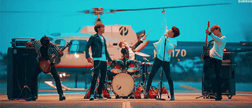 N Flying performs in front of a helicopter in their music video for Hot Potato