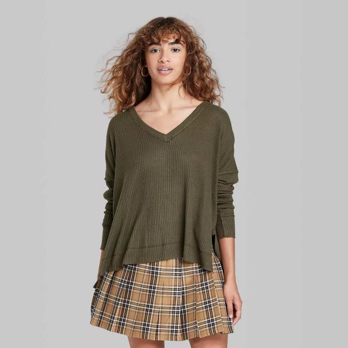 Model wearing forest green sweater