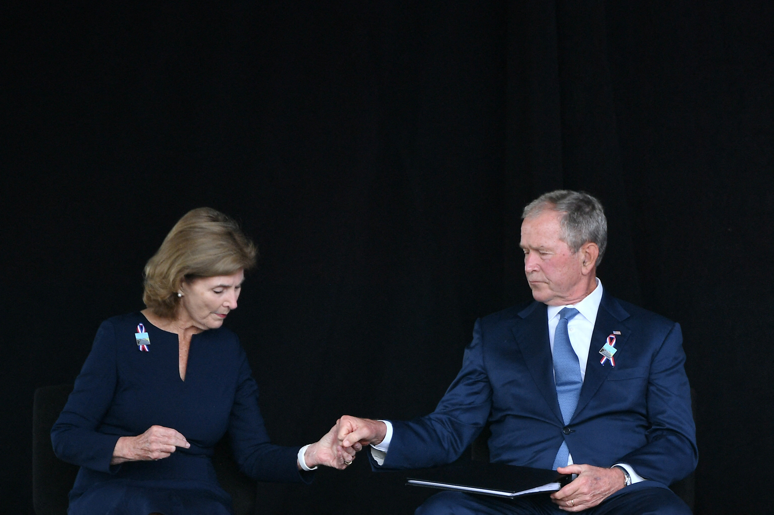 Laura and George hold hands