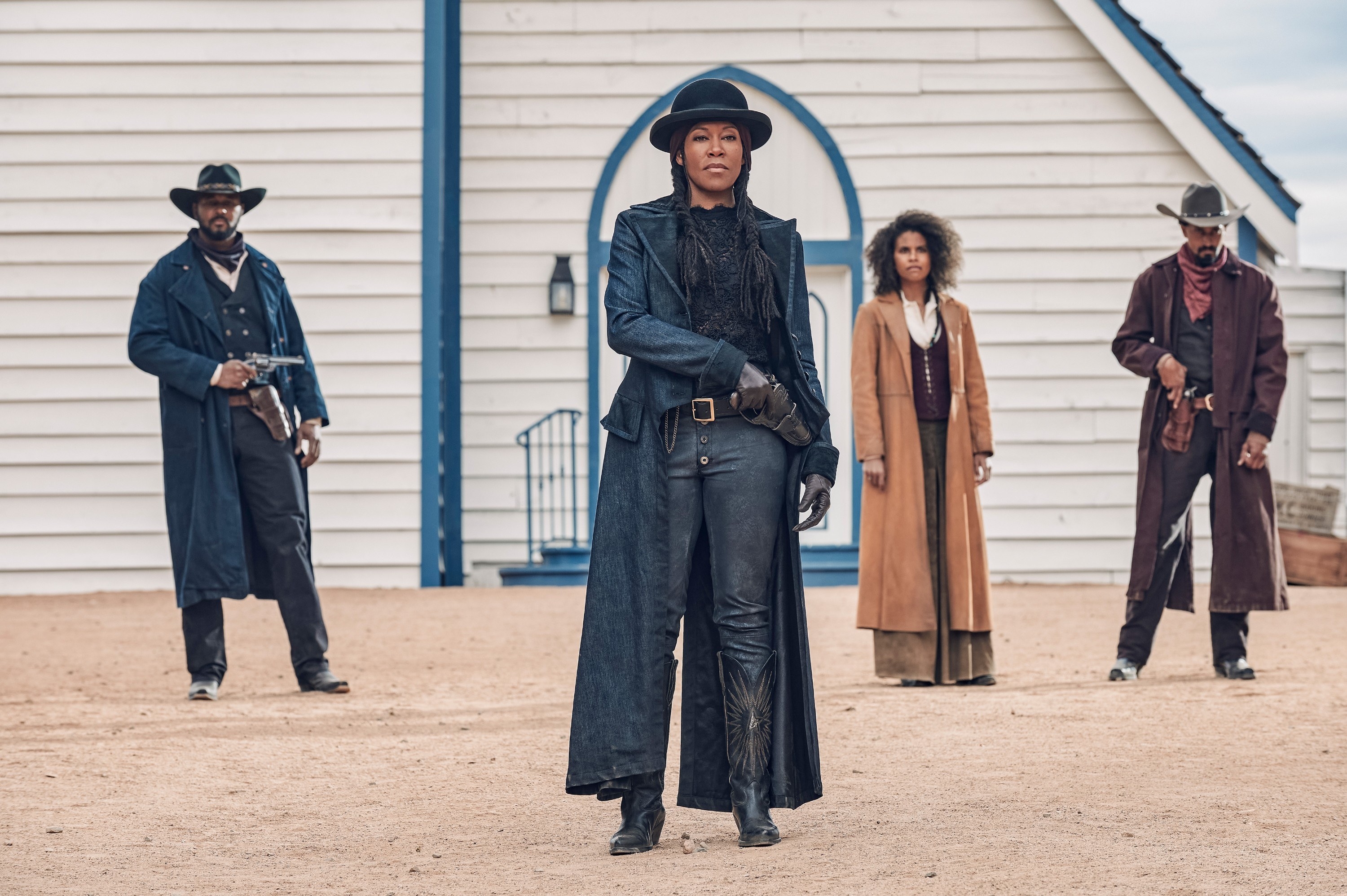 Regina King, Zazie Beets, and two other members of the cast standing in an open space guns at the ready