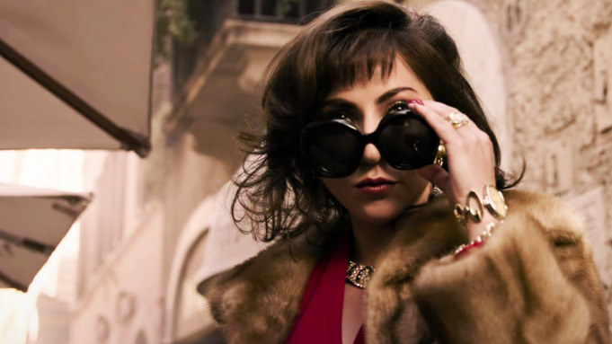 Lady Gaga looking over her sunglasses in a scene from House of Gucci