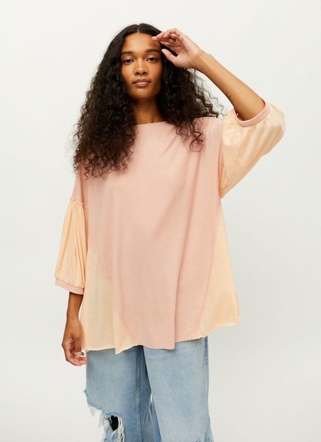 A model wearing the top in light mauve with jeans