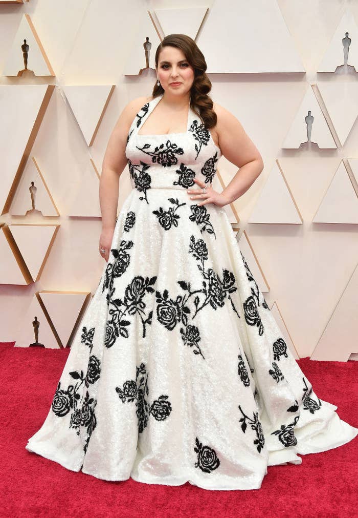 Beanie at the 2020 Oscars wearing a white Miu Miu gown adorned with black rose detailing
