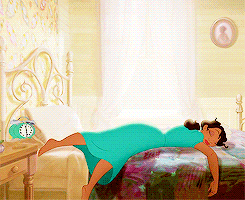 a gif of princess tiana sleeping and hitting an alarm clock with her foot