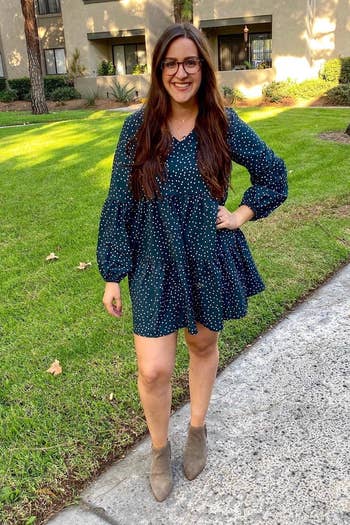 a reviewer wearing the dress in blue with white polka dots