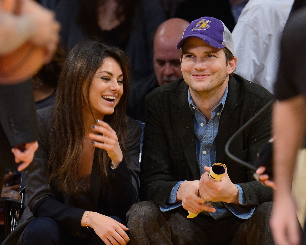 Ashton Kutcher (R) and Mila Kunis attend a basketball game between the Utah Jazz and the Los Angeles Lakers