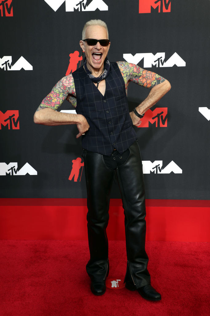 David Lee Roth on the red carpet in a black checkered vest and leather pants