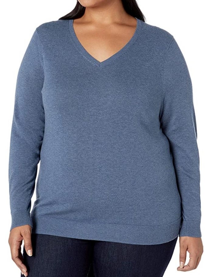 A model wearing a blue heather, long sleeve v-neck sweater